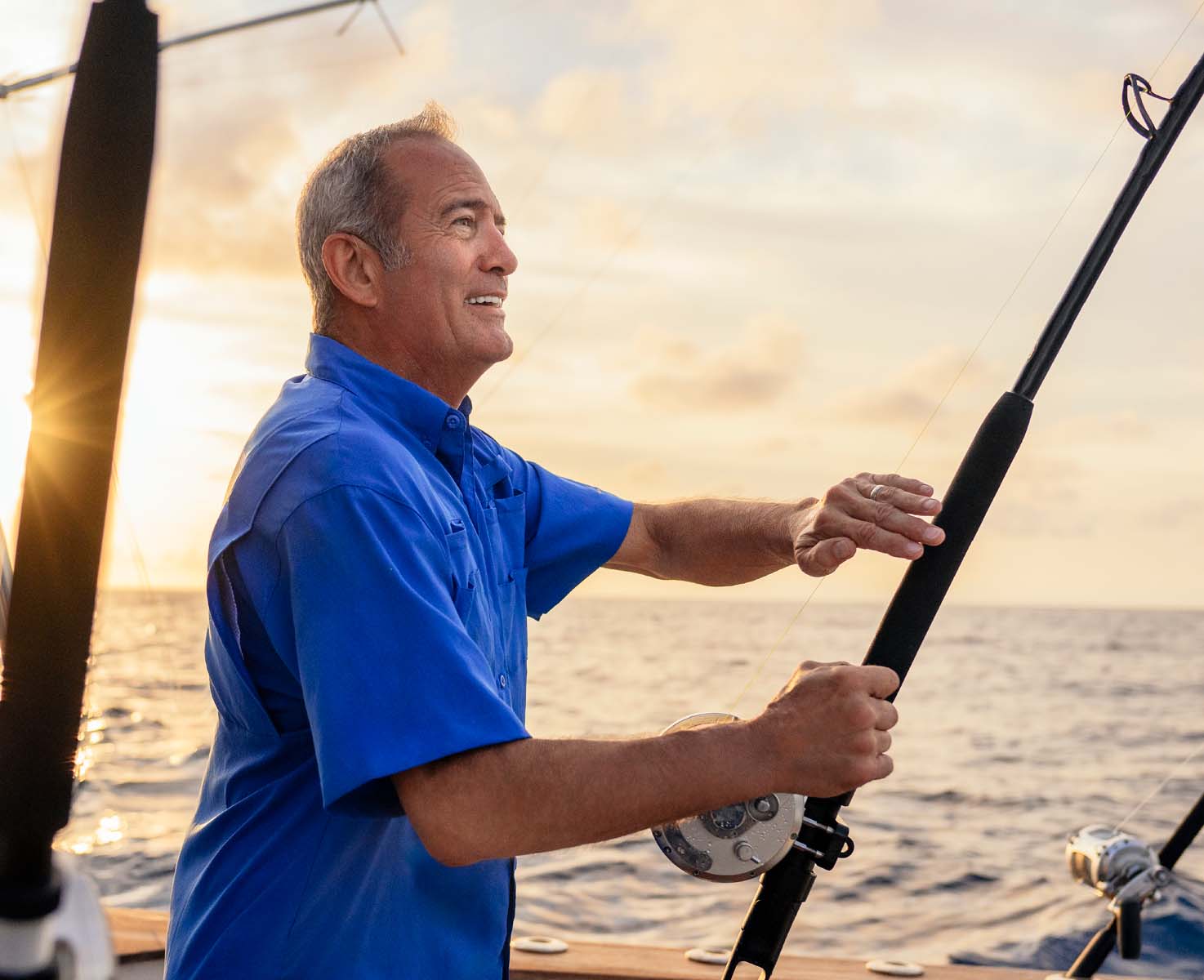 Kevin fishing on a boat
